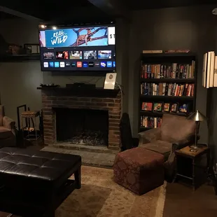 a flat screen tv above a fireplace