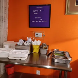 Plates, bowls, cutlery, and some chutneys
