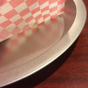 Burritos are served in metal pie plates for dine-in.
