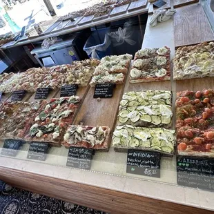 a variety of pizzas on display