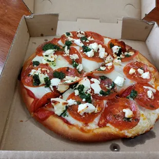 a pizza in a cardboard box