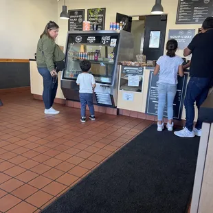 a woman and a child waiting in line