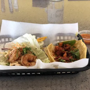 Baja Shrimp Taco on lettuce and Taco al Pastor. Both great!