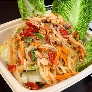 a plate of salad with lettuce and peanuts