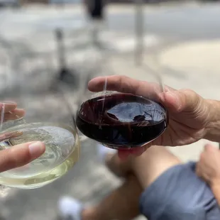 two people holding wine glasses