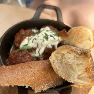 a skillet of food with bread