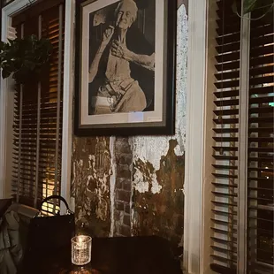 a candle lit in front of a picture of a baseball player