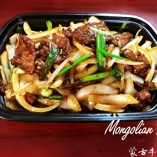 beef and noodles in a black container