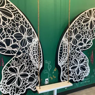 two butterfly wings painted on a green wall