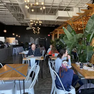 people sitting at tables in a cafe