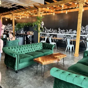 a woman standing in front of a green couch