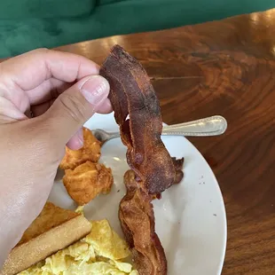 Extremely burnt and dried out bacon