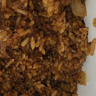 This fried rice is dark for no reason, and just flavorless. It reminds my of reheated rice-a-roni with onions..