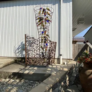 a wine bottle sculpture in the front yard