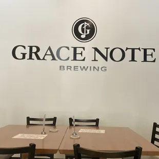 a table and chairs in front of a sign