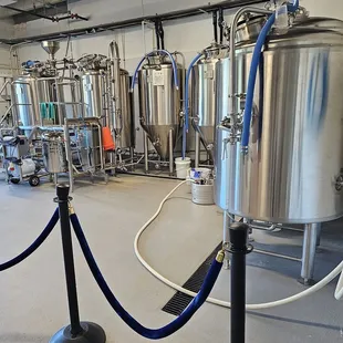 a row of stainless steel tanks