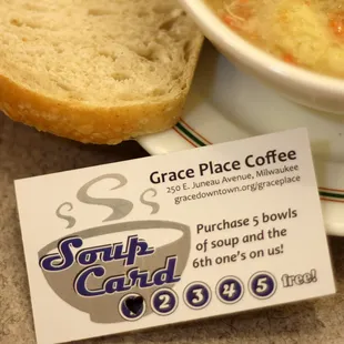 a bowl of soup and a piece of bread
