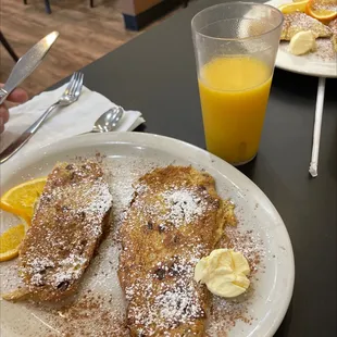 a plate of french toast and orange juice