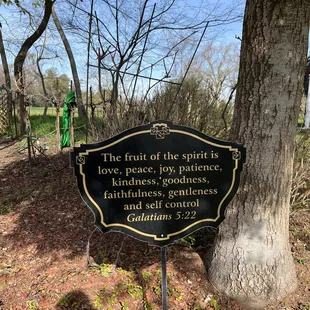 a plaque in front of a tree