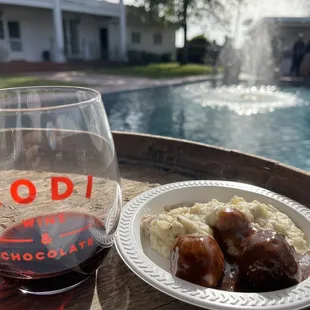 a glass of wine and a plate of food