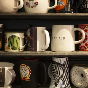 a shelf full of coffee mugs