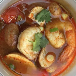 Tom Yum Soup - A Thai herb soup w/chili paste, tomato, mushrooms, onion, cilantro, lime juice, fish sauce &amp; served w/chicken or shrimp.