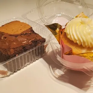 The brownie-cookie is on the left, and the White Chocolate Raspeberry cupcake is on the right.