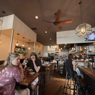 a group of people sitting at a bar