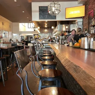 a bar with stools at the bar