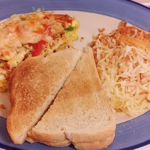 Fajita omelet with stir fry chicken,hash browns and sour dough toast.