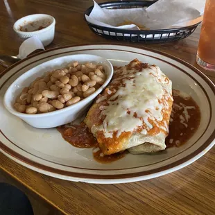 a plate of enchiladas and beans