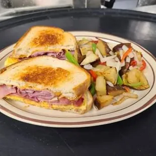 Egg sandwich with ham and home fries
