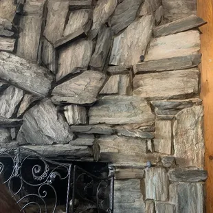 a fireplace with a stone wall
