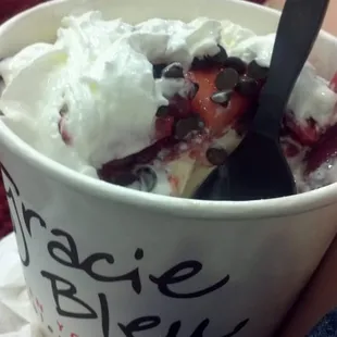 a person holding a cup of ice cream