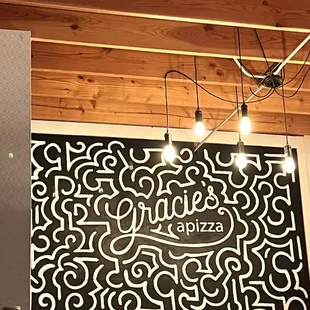 a black and white sign hanging from the ceiling