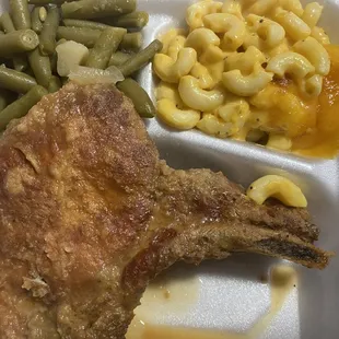 Smothered pork chop with green beans and mac n cheese