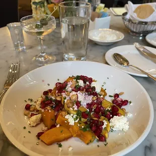 Winter Squash Salad with pomegranate seeds, ricotta and pepitas, offered on Thanksgiving 2021