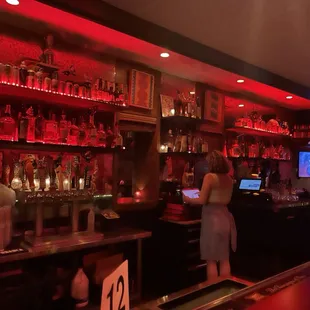 a woman standing at the bar