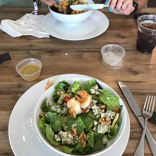 a woman eating a salad at a restaurant