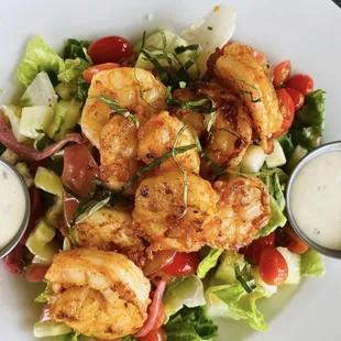 a salad with shrimp and tomatoes