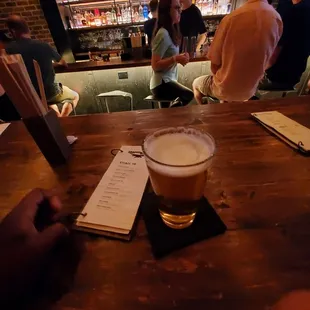 a pint of beer on the bar counter