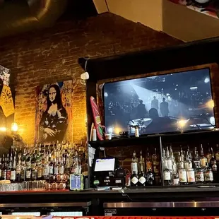 a bar with a television and a bar counter