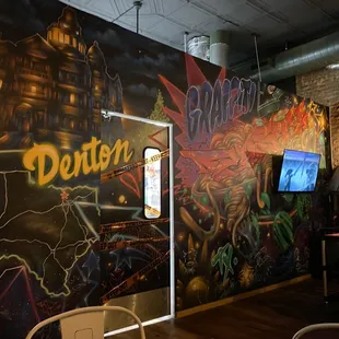 a restaurant with a chalkboard mural
