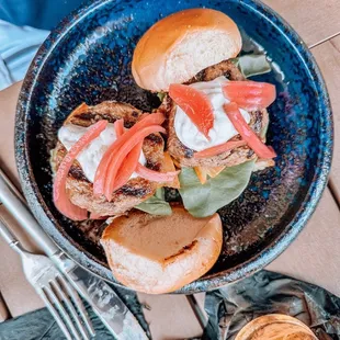 a plate of burgers and a glass of beer