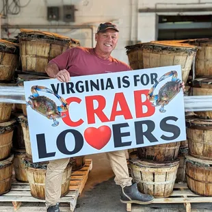 a man holding a crab lover sign