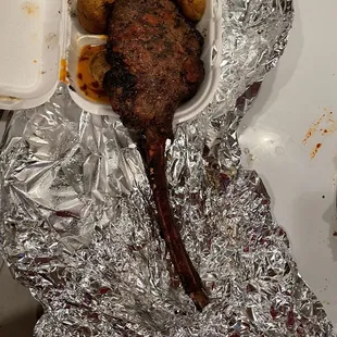 a piece of meat wrapped in tin foil