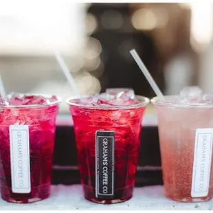 three different drinks on a window sill