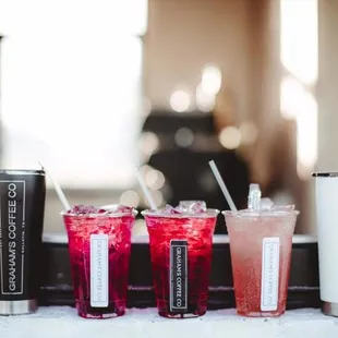 a variety of drinks on a window sill