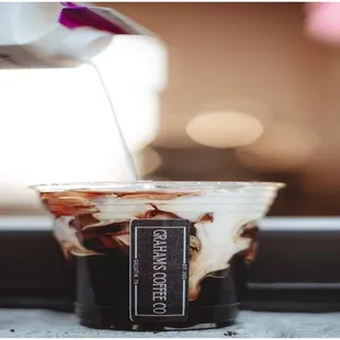 a cup of coffee being poured