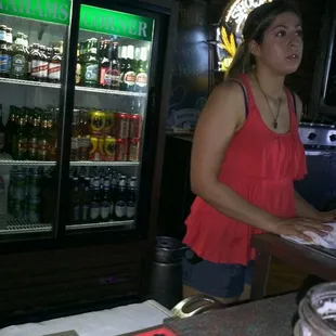 a woman standing at a bar